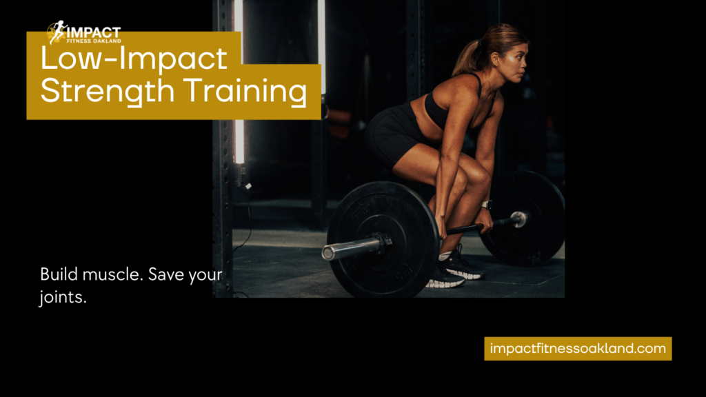 Low-impact strength training at Impact Fitness Oakland — woman performing a controlled barbell deadlift
