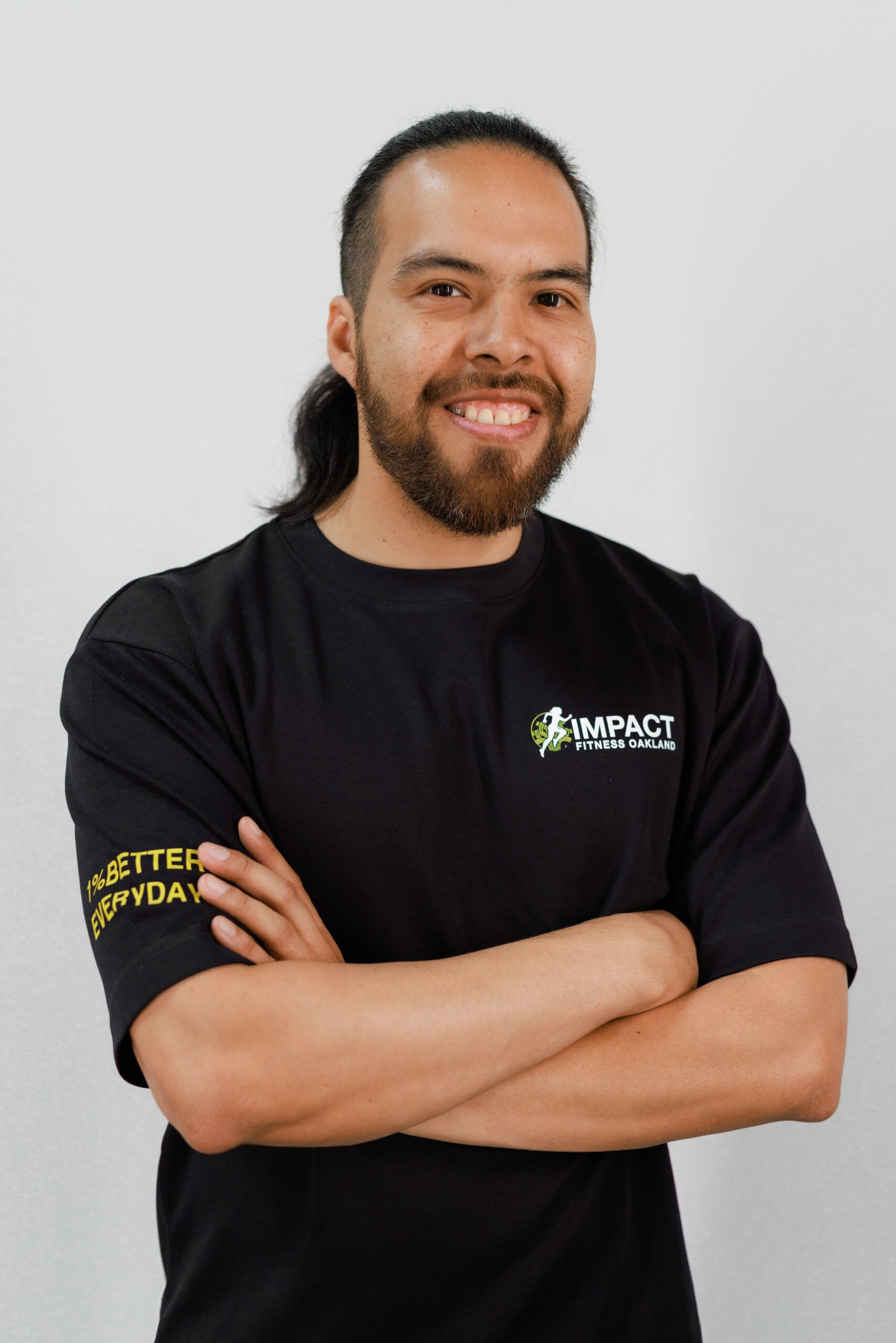 Ed Osorio, certified personal trainer at Impact Fitness Oakland, arms crossed and smiling